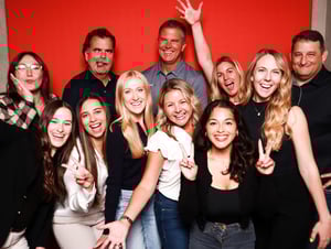 gogather team in front of red background making fun faces