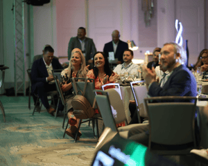 attendees sitting at awards ceremony celebrating