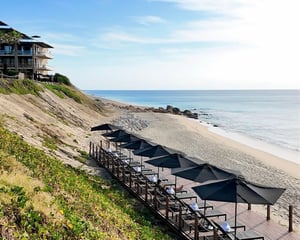 cabo beach side with chairs and umberllas