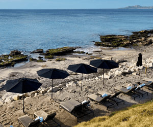 view of ocean and beach chairs in cabo