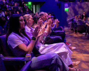 clapping attandees at a conference general session