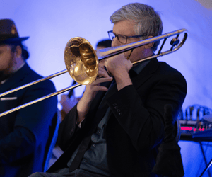 man playing the trombone during a corporate event