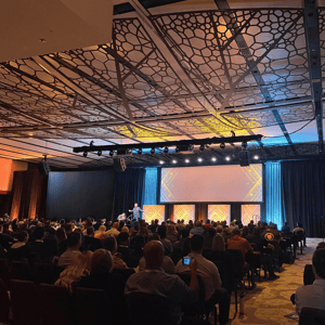 group of event attendees watching a corporate conference presentation