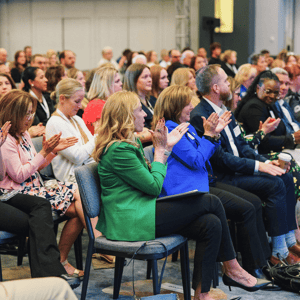 event attendees clapping during a conference presentation