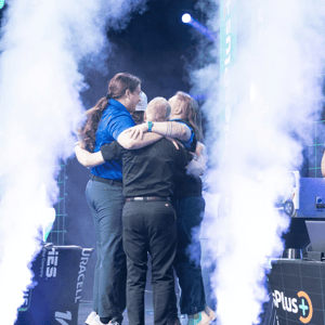 group of attendees celebrating a win on stage