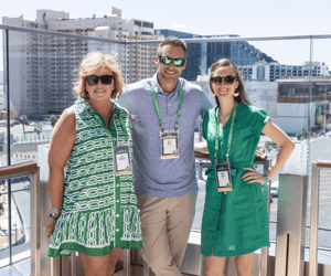 three attendees at a rooftop pool