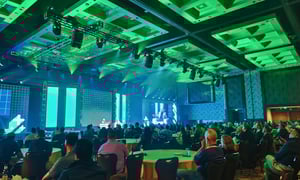 group of attendees watching a presentation at a franchise convention