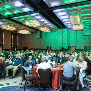 group of franchisees clapping during an event presentation