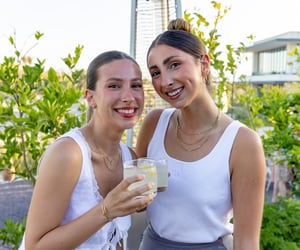 two girls at a corporate event drinking mocktails