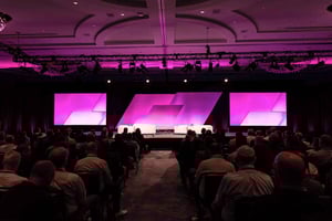 group of attendees watching a presentation