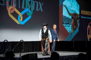 cowboy walking onstage during a conference