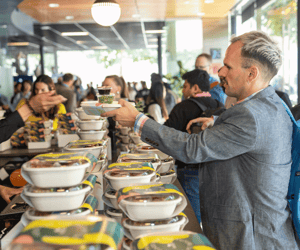 event attendees getting boxed lunch during an event
