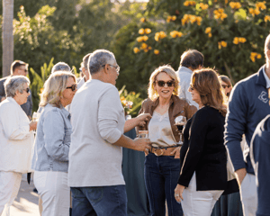 group of attendees networking outside at a cocktail hour 