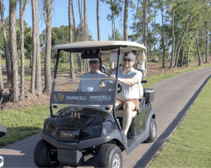 golfers in cart playing a round 